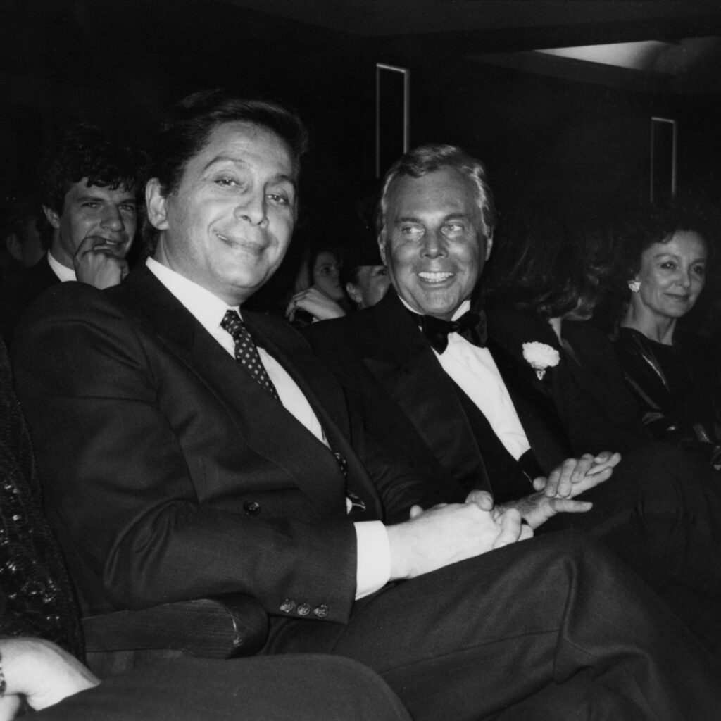 +Valentino Garavani and Giorgio Armani are seated in an audience in formal wear (Photo by Fairchild ArchivePenske Media via Getty Images) - GettyImages-1460936158