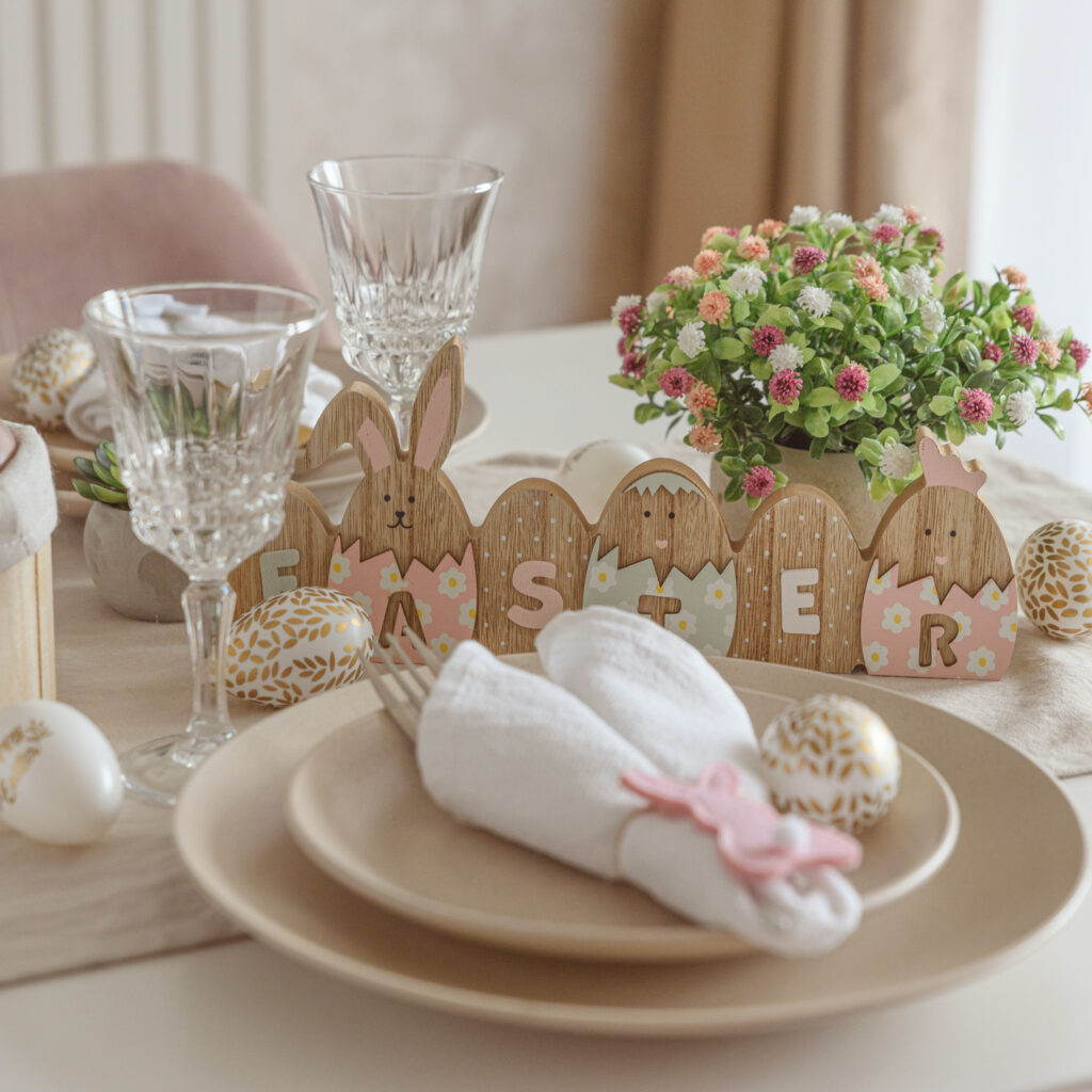 Festive Easter table setting with Easter bunny made from napkin. Easter celebration concept