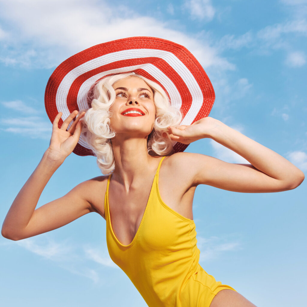 lip balm spf cheerful-woman-in-a-yellow-swimsuit-wearing-a-large-hat