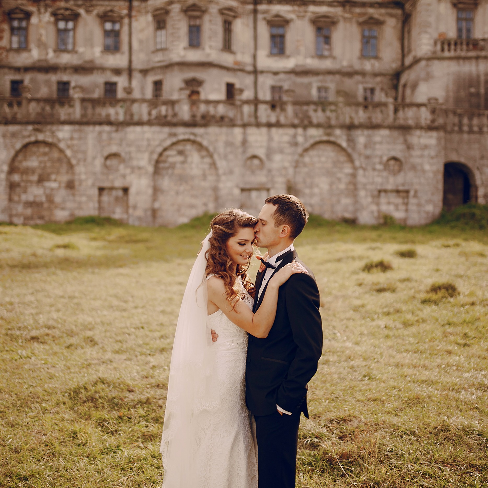 beautiful couple in wedding dress outdoors near the castle