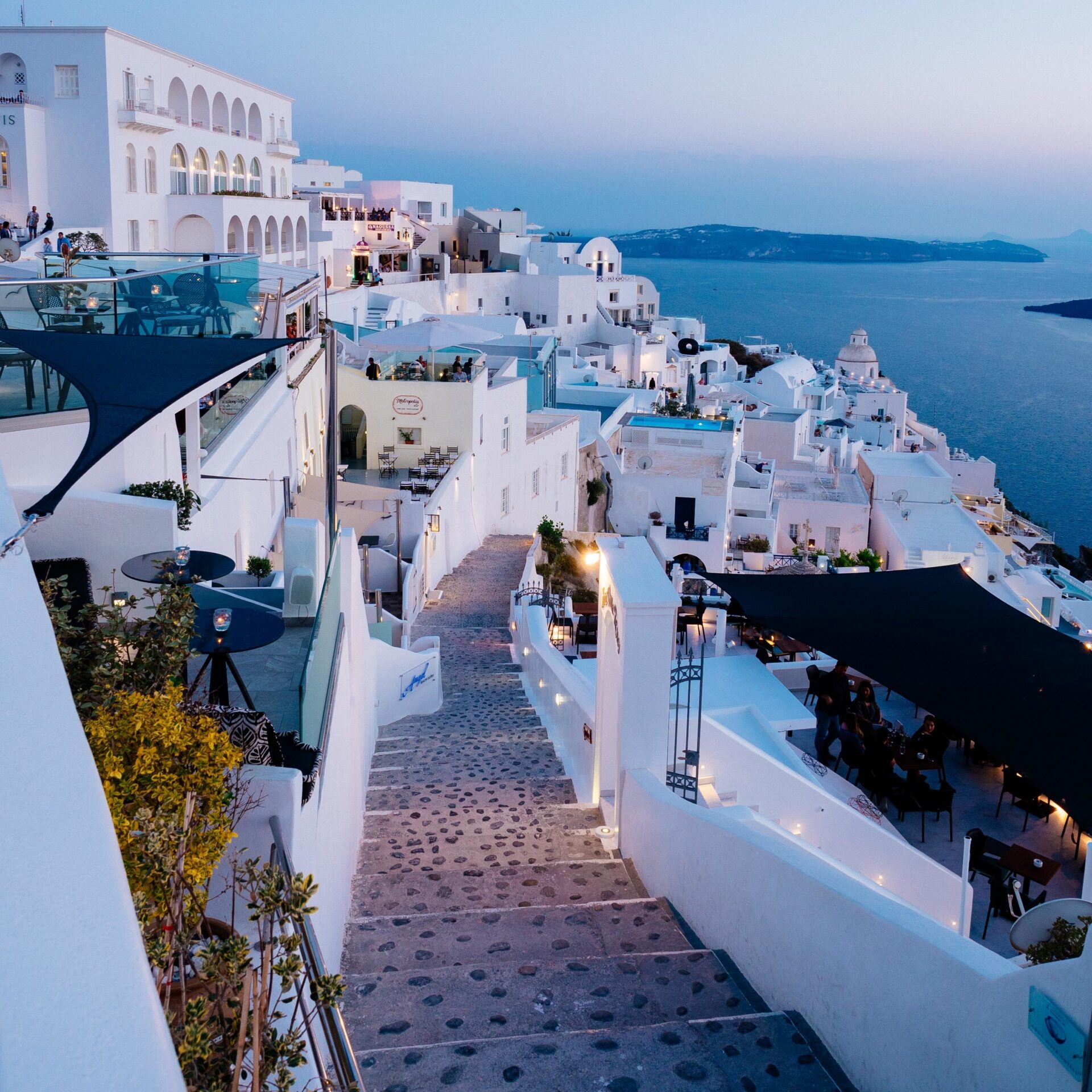 A vertical high angle shot of the white buildings in Santorini, Greece