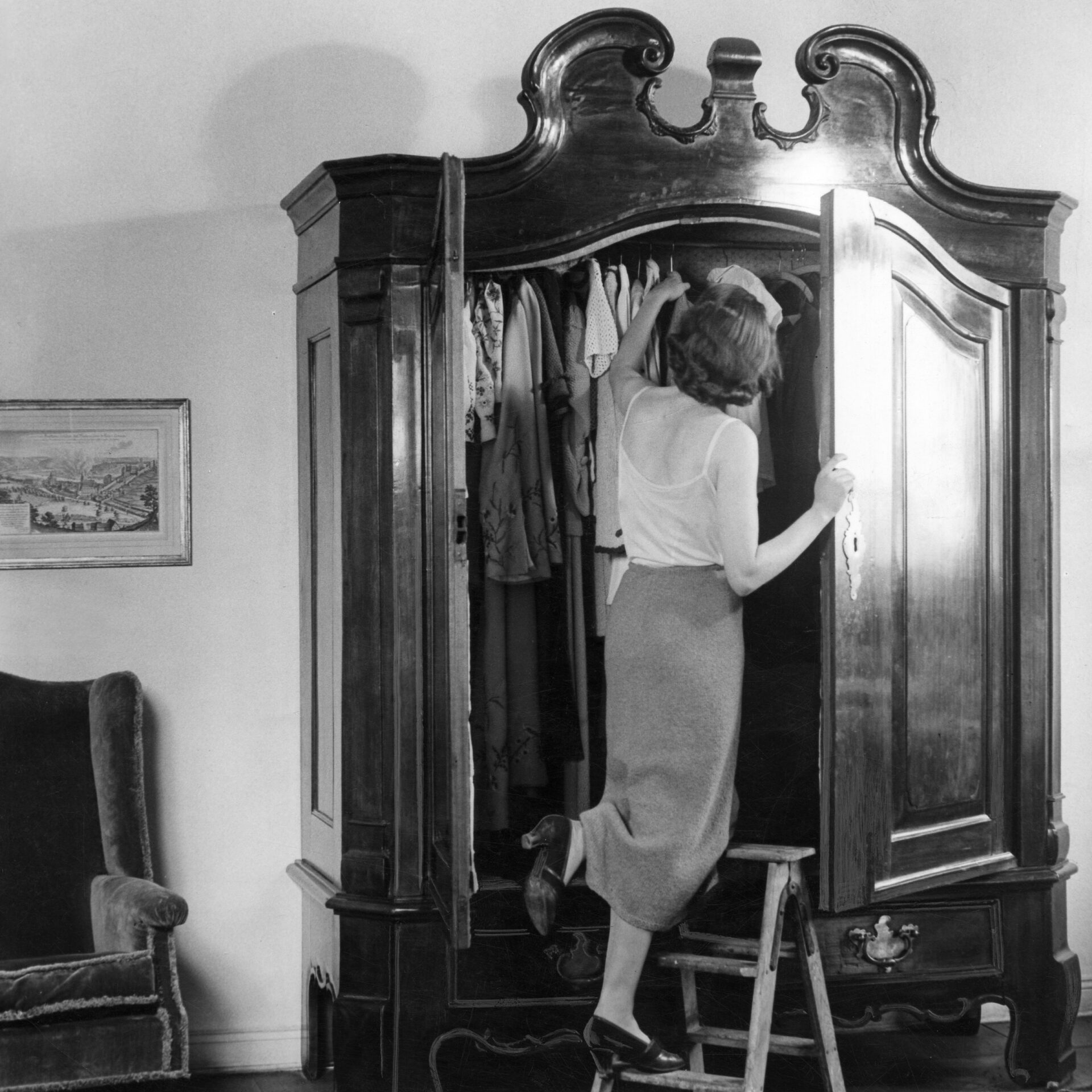German Empire : Young woman taking out clothes from the wardrobe - Photographer: Peter Weller- Published by: 'Das Blatt der Hausfrau' 5/1937/1938Vintage property of ullstein bild